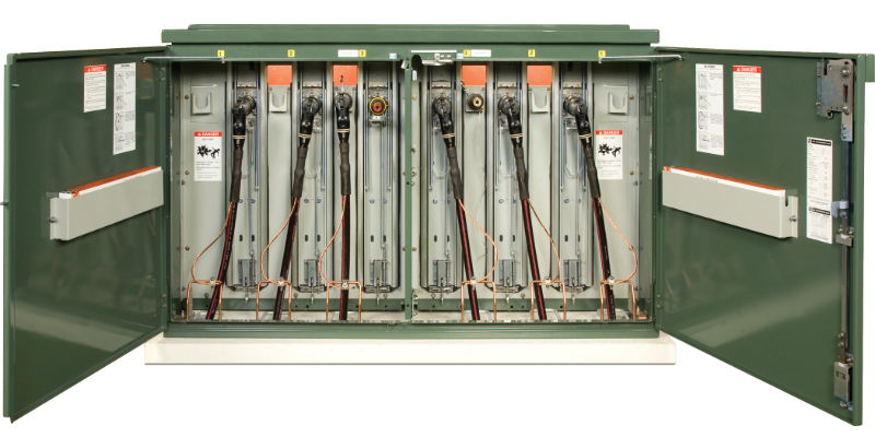 Green Remote Supervisory PME unit with its fuse-side doors swung open. Some of the unit’s six elbow connections are connected to bushings while others hang in the storage compartments beside the bushings. Green Remote Supervisory PME unit with its fuse-side doors swung open. Some of the unit’s six elbow connections are connected to bushings while others hang in the storage compartments beside the bushings.